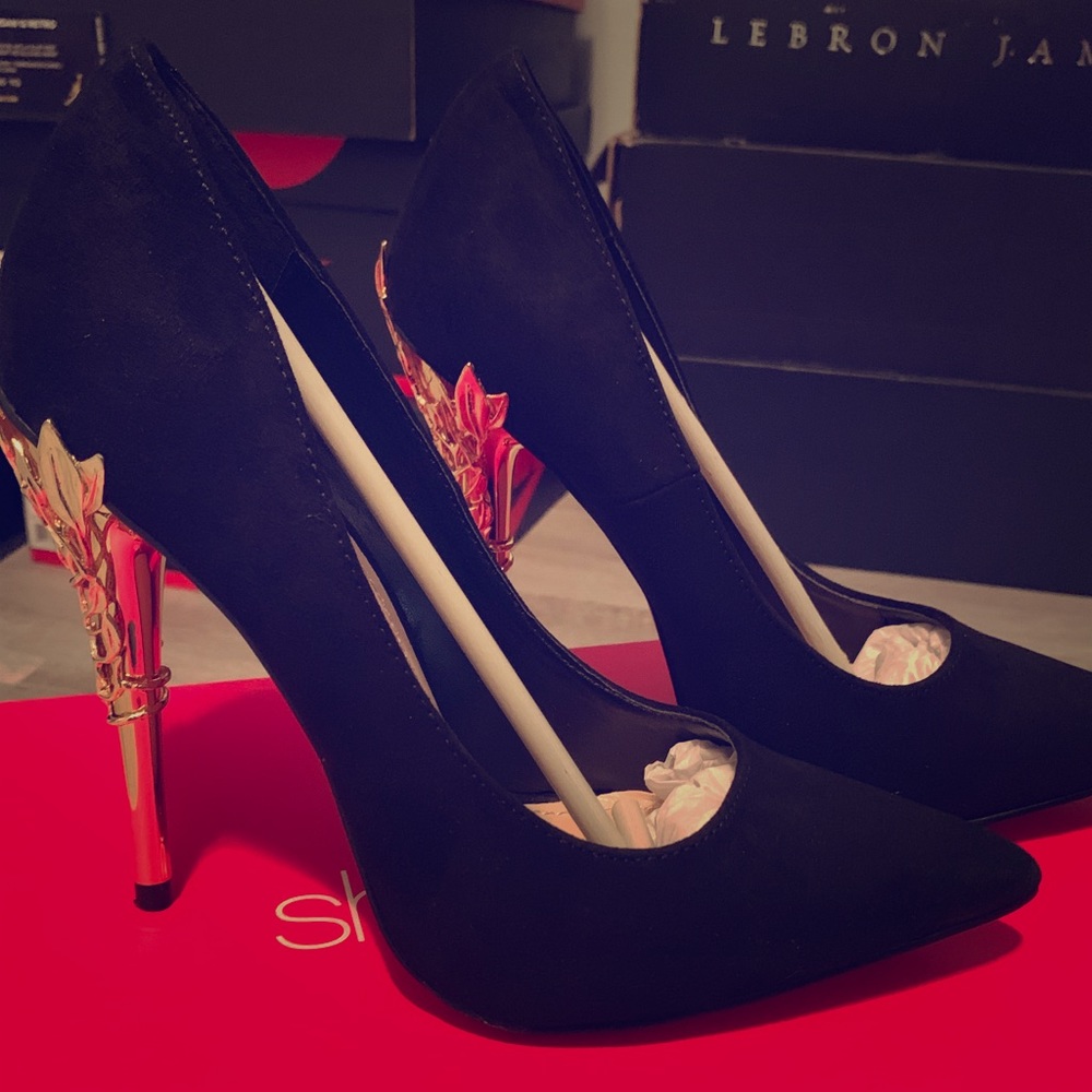 Black pumps with metallic gold heel.
